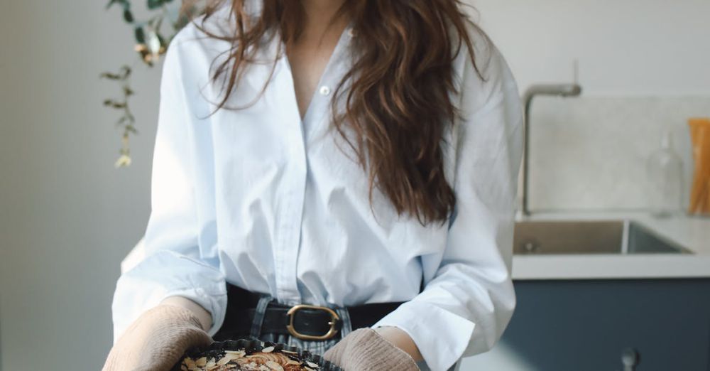 Tart Pans - Young woman holding freshly baked goods, filmed in a modern kitchen setting.