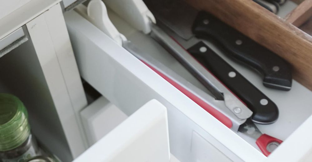 Drawer Dividers - Neatly arranged kitchen drawer with knives and utensils, showcasing effective organization.