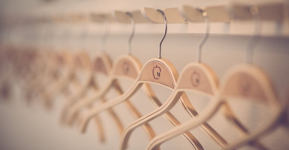 Hangers - Close-up of neatly organized wooden hangers in a modern indoor wardrobe setting.