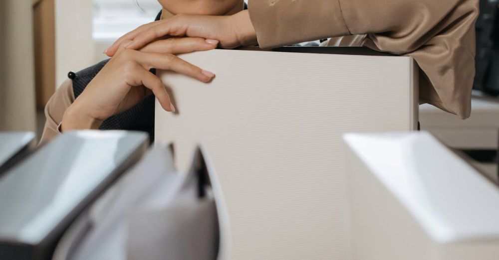 Desk Organizers - Businesswoman organizing office binders indoors. Focused expression.