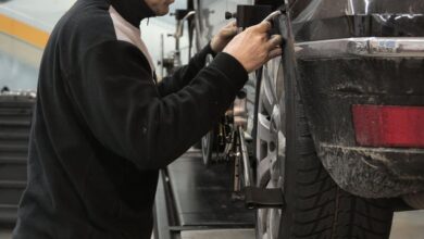 Garage Products - Professional mechanic adjusting wheel alignment for optimal performance in auto repair shop.