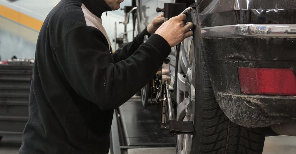 Garage Products - Professional mechanic adjusting wheel alignment for optimal performance in auto repair shop.