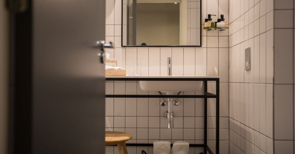 Bathroom Storage - Stylish bathroom with white tiles and modern fixtures in London, UK.