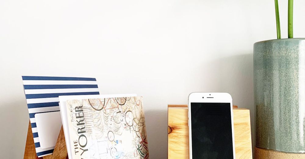 Magazine Holders - A clean desk with a plant, phone holder, and wooden magazine holders, perfect for a modern minimalist look.