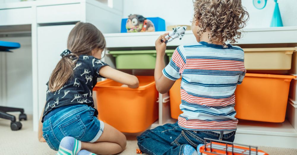 Toy Storage - Two kids playing with toys and colorful bins in a playful indoor setting.