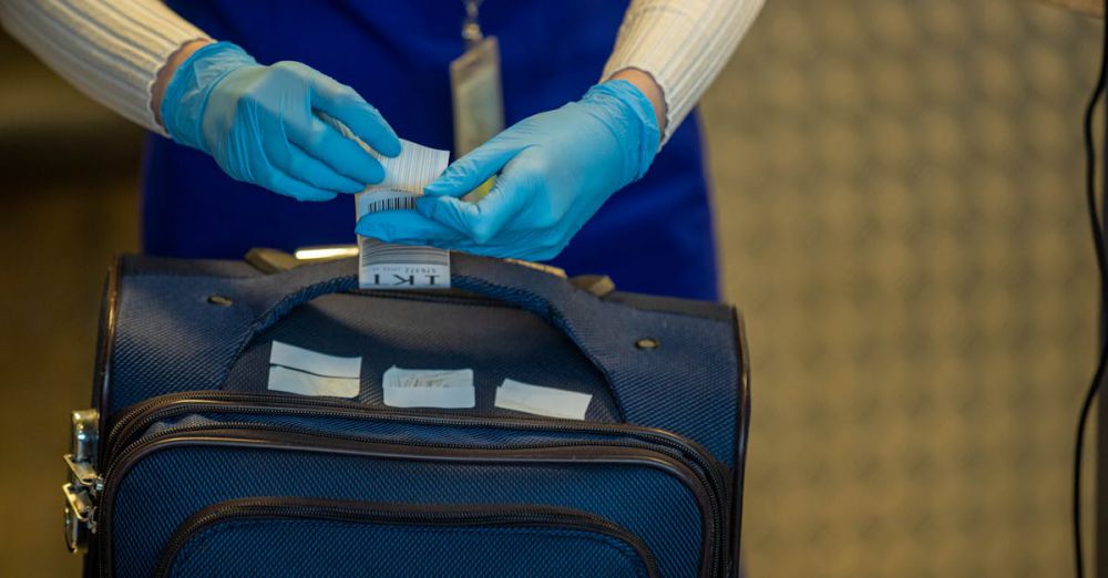 Luggage Tags - Close-up of airport security process with gloved hands inspecting luggage tags.