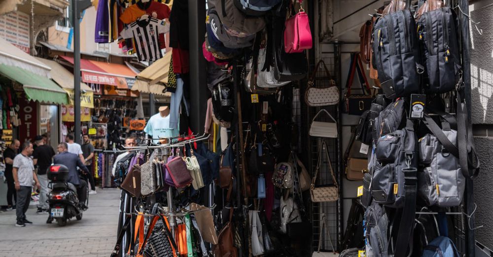 Travel Wallets - Explore vibrant market street stalls selling various bags in İzmir, Türkiye.