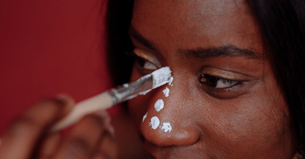 Shoe Organizers - A close-up portrait of a woman getting traditional face paint applied during a studio shoot.