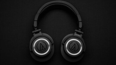 Headphones - Close-up of black over-ear headphones on a black background, showcasing modern design.