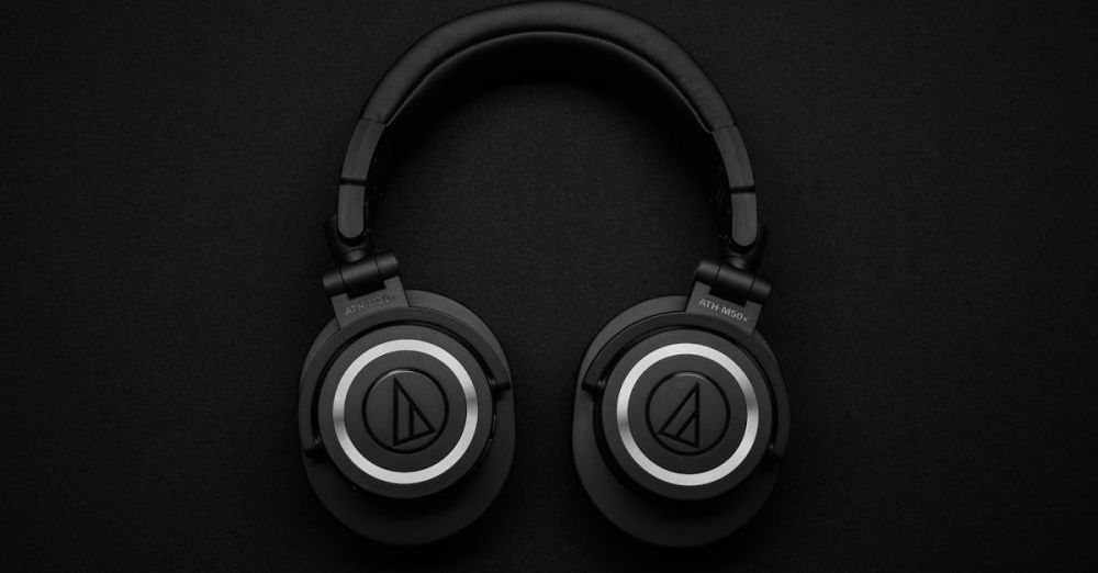 Headphones - Close-up of black over-ear headphones on a black background, showcasing modern design.