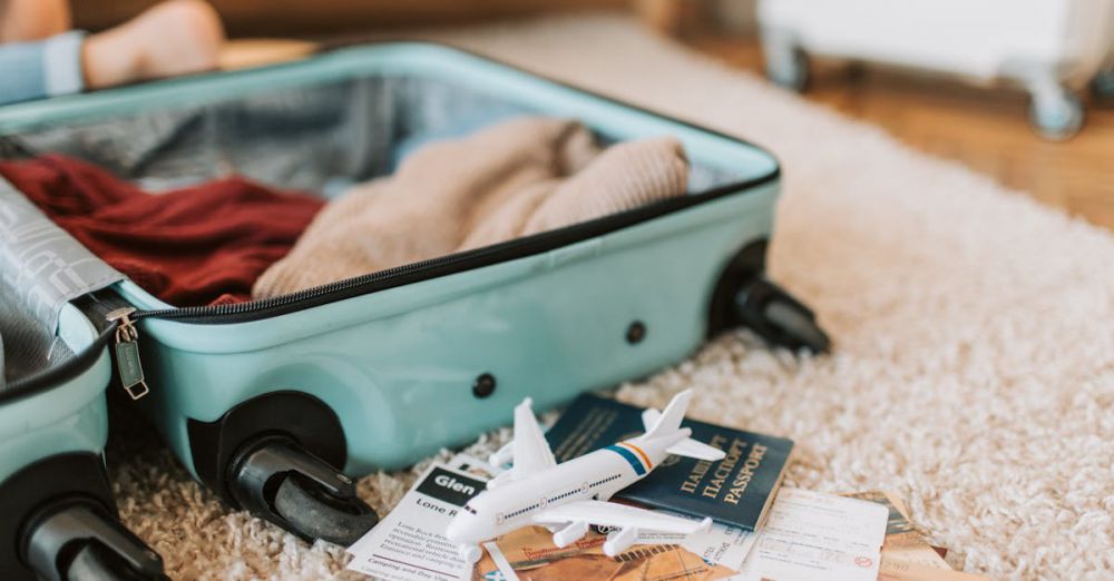 Luggage Sets - Close-up of an open suitcase with travel essentials like passport and tickets, ready for a journey.