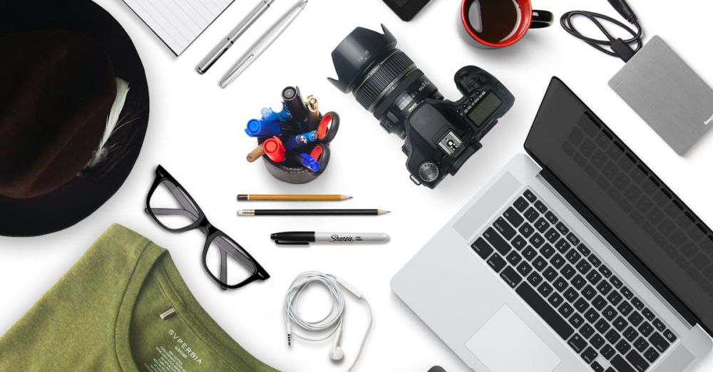 Gadgets - Top view of a creative workspace with camera, laptop, and accessories, perfect for a designer or photographer.