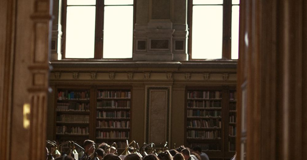 Educational Books - Students studying diligently in a historic library with ambient lighting.