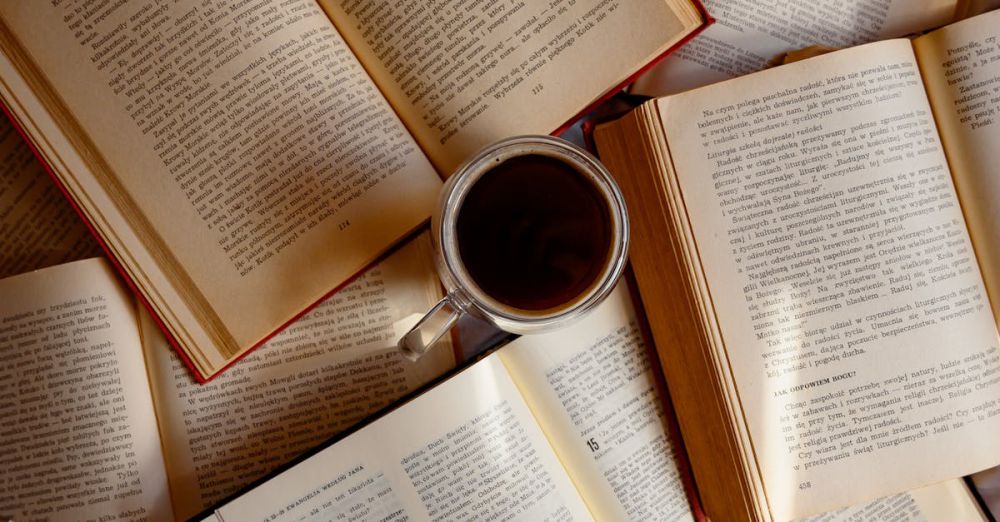 Chapter Books - Top view of scattered open books with a cup of coffee in the center.