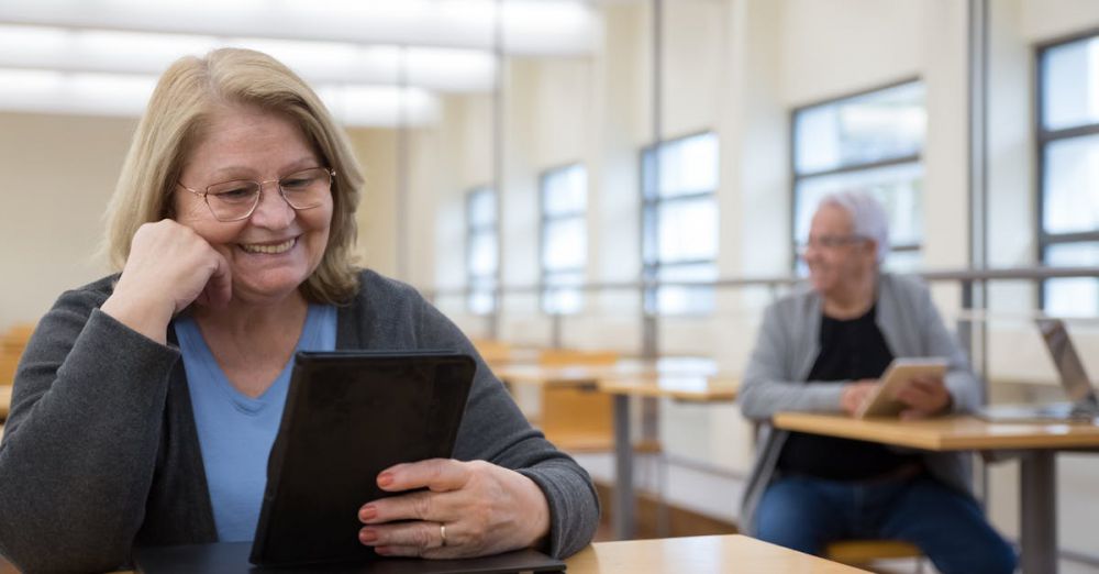 Learning Tablets - Senior adults learning to use tablets at a modern classroom in Portugal.