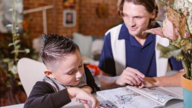 Coloring Books - An adult and child bonding over a coloring activity indoors. Enhancing creativity and family time.