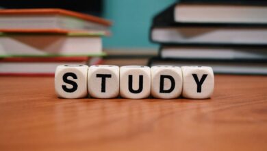 Learning Tools - Close-up of study blocks and stacked books on a wooden desk, symbolizing education and learning.