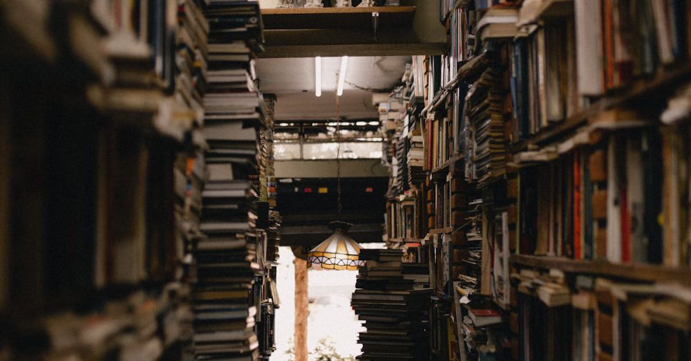 Story Collections - A densely packed library aisle with numerous stacks of books creating a warm and inviting atmosphere.