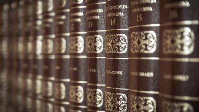 Encyclopedias - A close-up view of vintage encyclopedias on a library bookshelf, highlighting the ornate leather bindings.