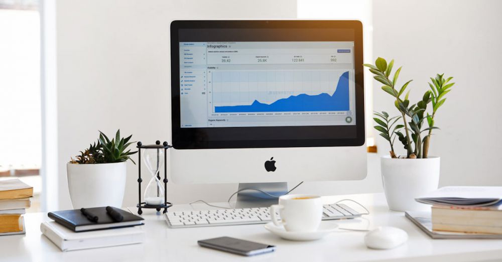 Pop-Up Books - A clean, contemporary workspace featuring a desktop with analytics on the screen and plants for a fresh look.