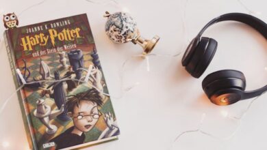 Audiobook Subscriptions - Minimalist setup with Harry Potter book, headphones, and string lights for a cozy reading experience.