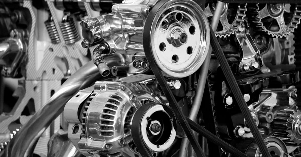 Gear - Close-up of a shiny car engine showing polished metal parts and gears in black and white.