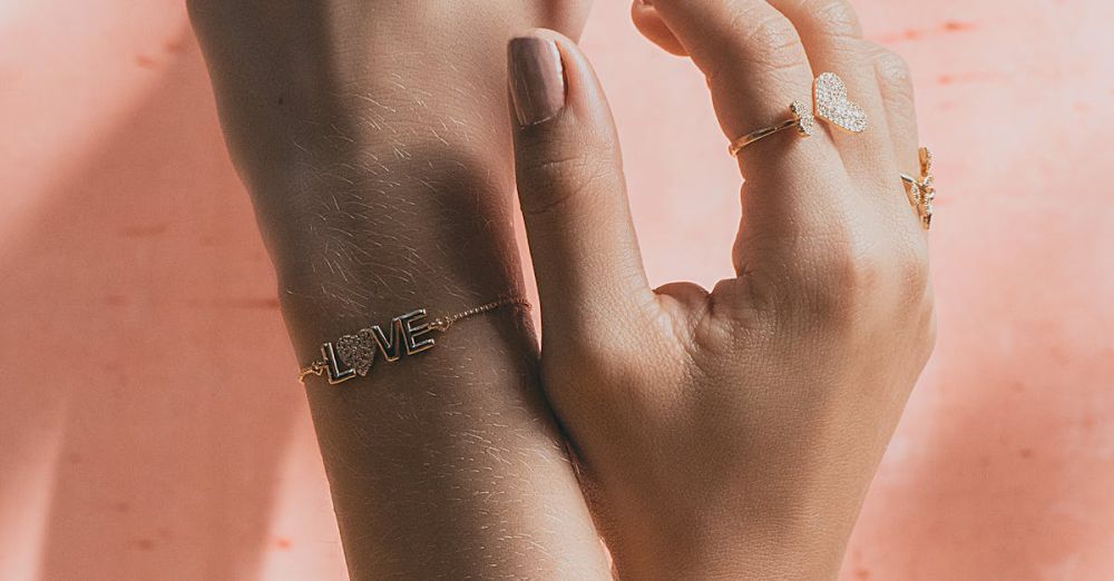 Jewelry Trends - Close-up of hands adorned with delicate rings and bracelets against a soft background.