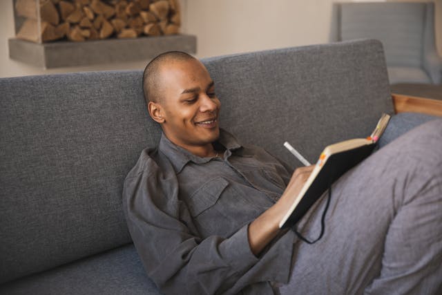 photo-of-man-writing-on-a-notebook
